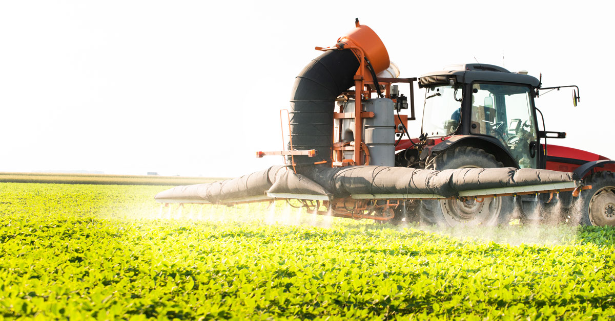 Tractor pulverizando glifosato en un campo de soja